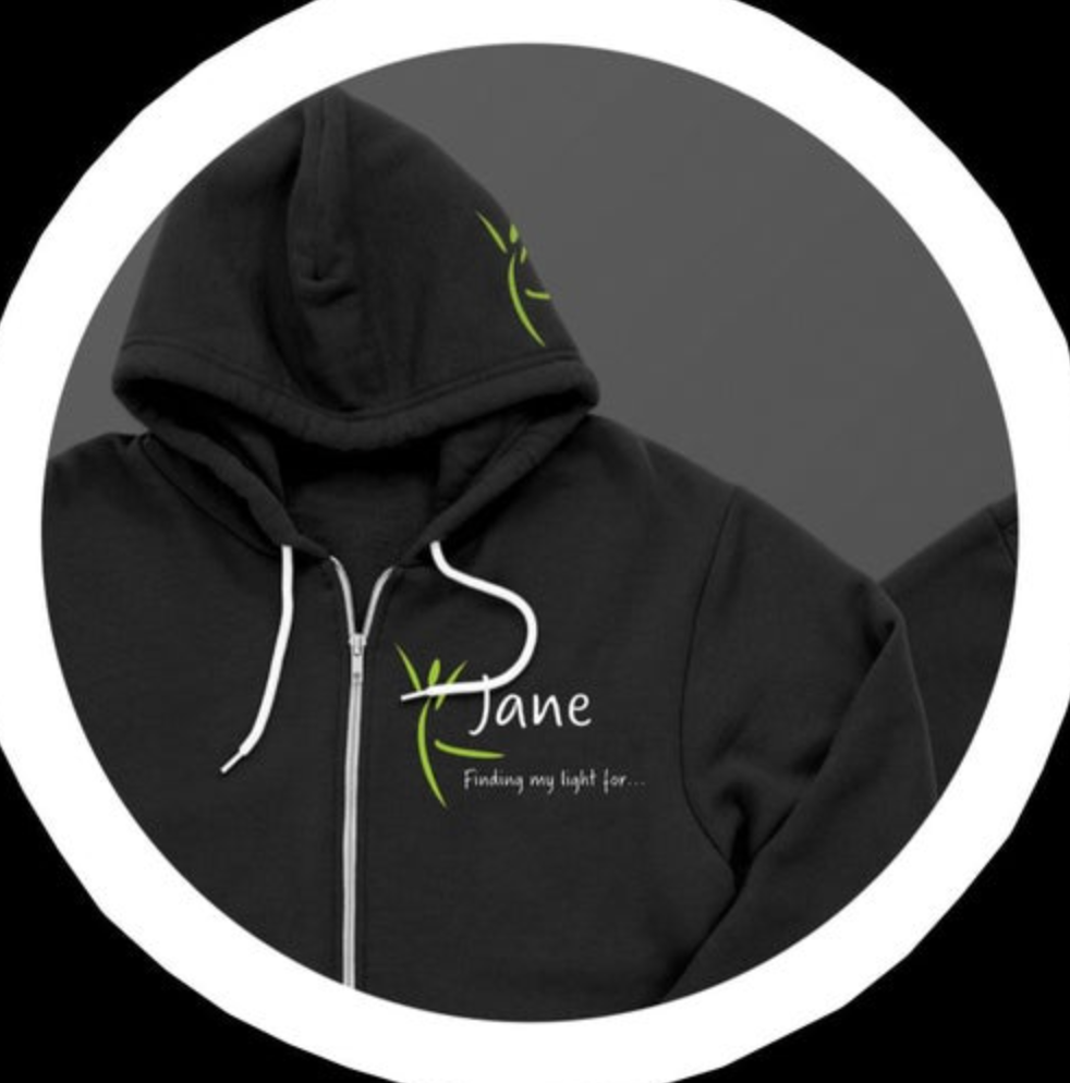 Digital product image of a black zip-up hoodie with white drawstrings and zipper, featuring a lime green 'Jane' logo with a leaf design and the text 'Finding my light for...' on the chest, plus a small matching design on the hood