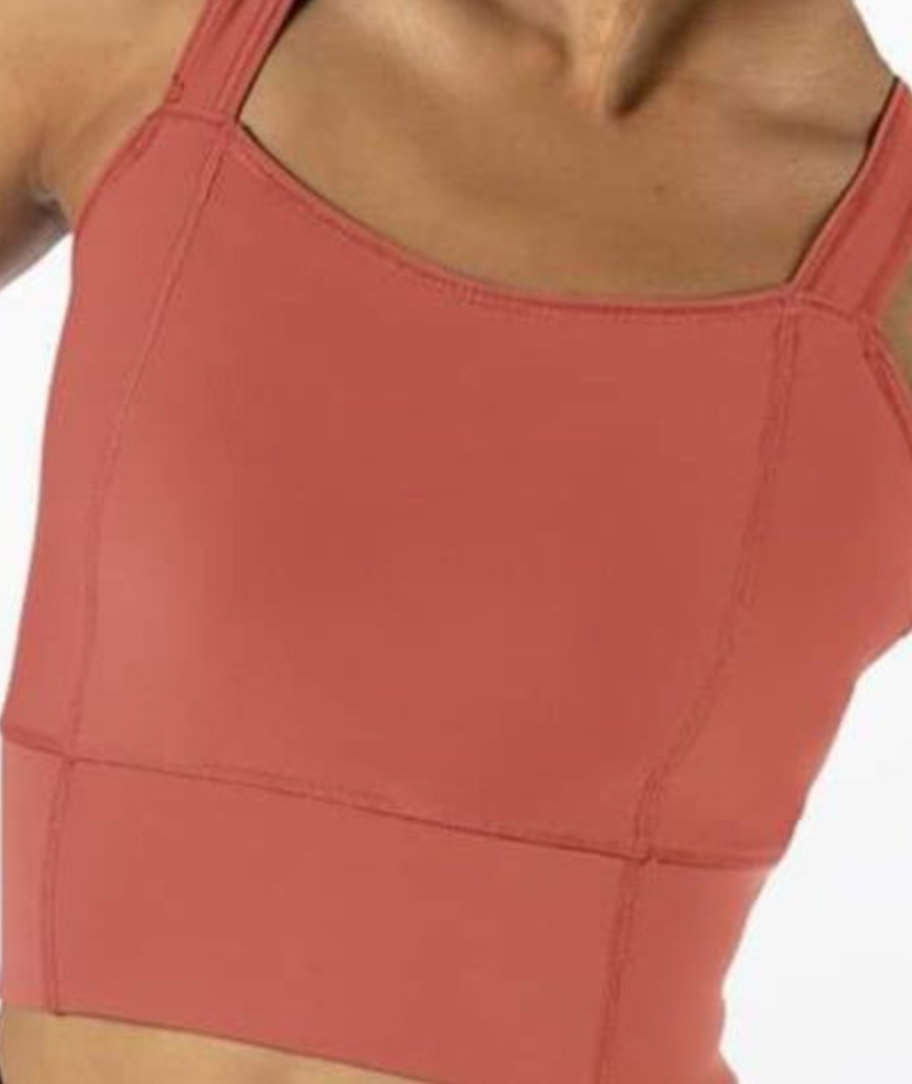 Earthy coral cropped athletic tank top with a square neckline, wide straps, and visible seam detailing