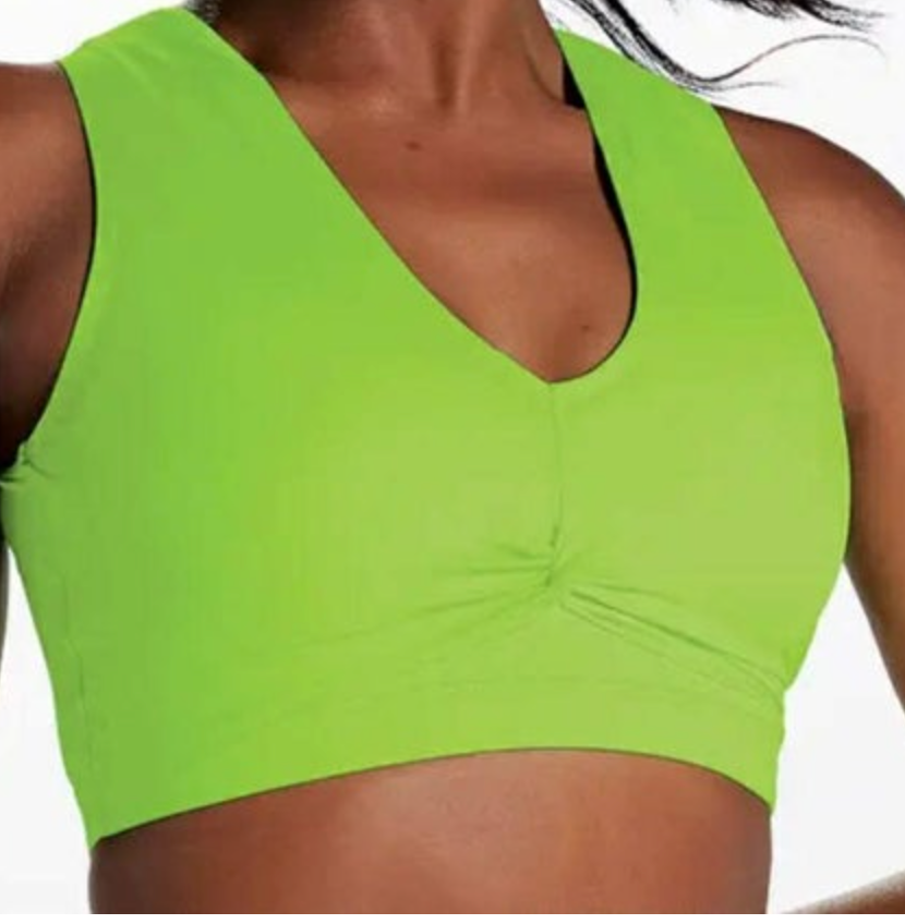 Close-up of a person wearing a vibrant lime green V-neck sports bra featuring central front ruching