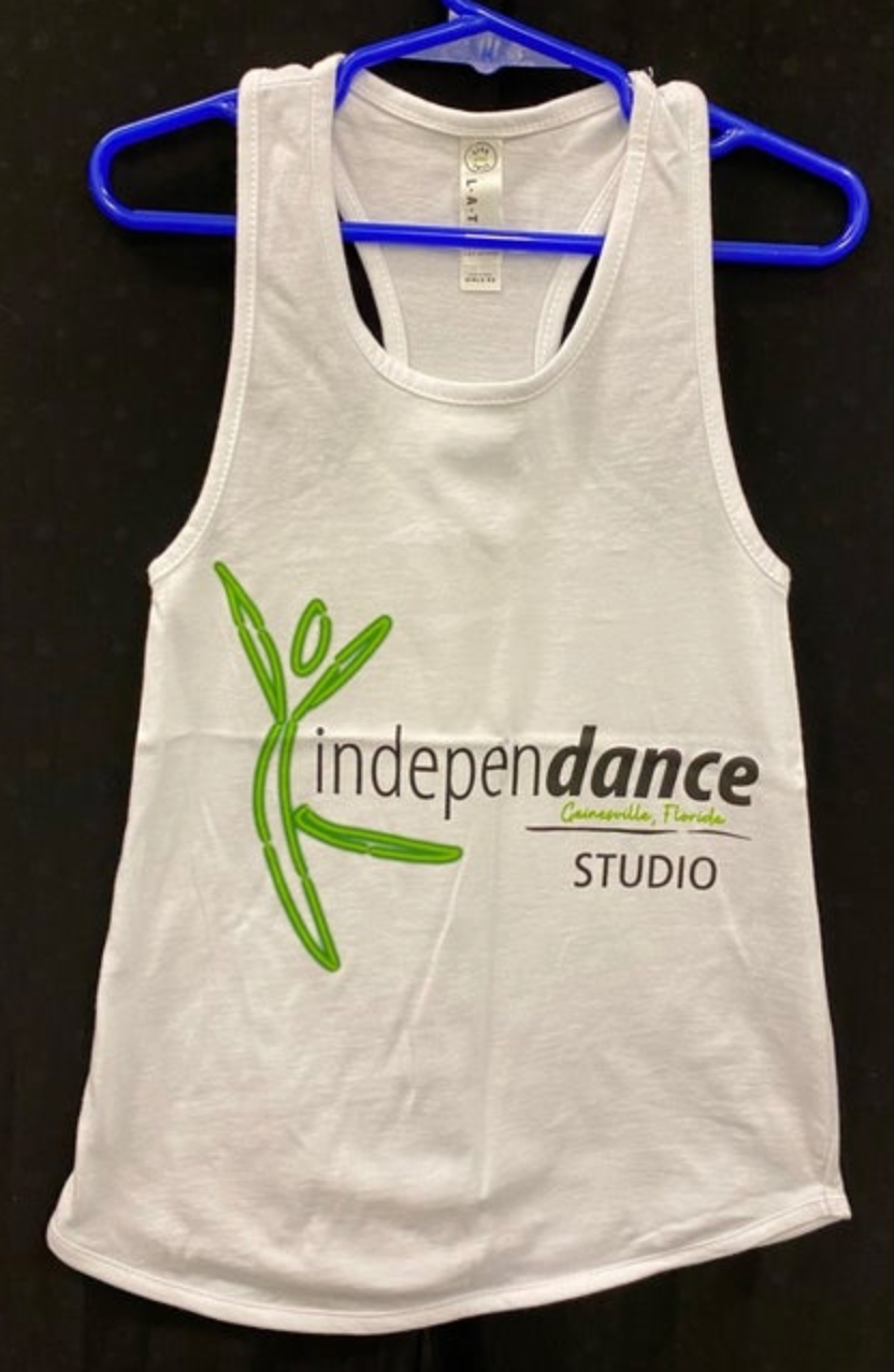 Photograph of a white racerback tank top for Independance Studio, Gainesville Florida, featuring a vibrant green abstract dancer logo, black "independance" and "STUDIO" lettering, and green "Gainesville, Florida" below, presented on a bright blue plastic hanger