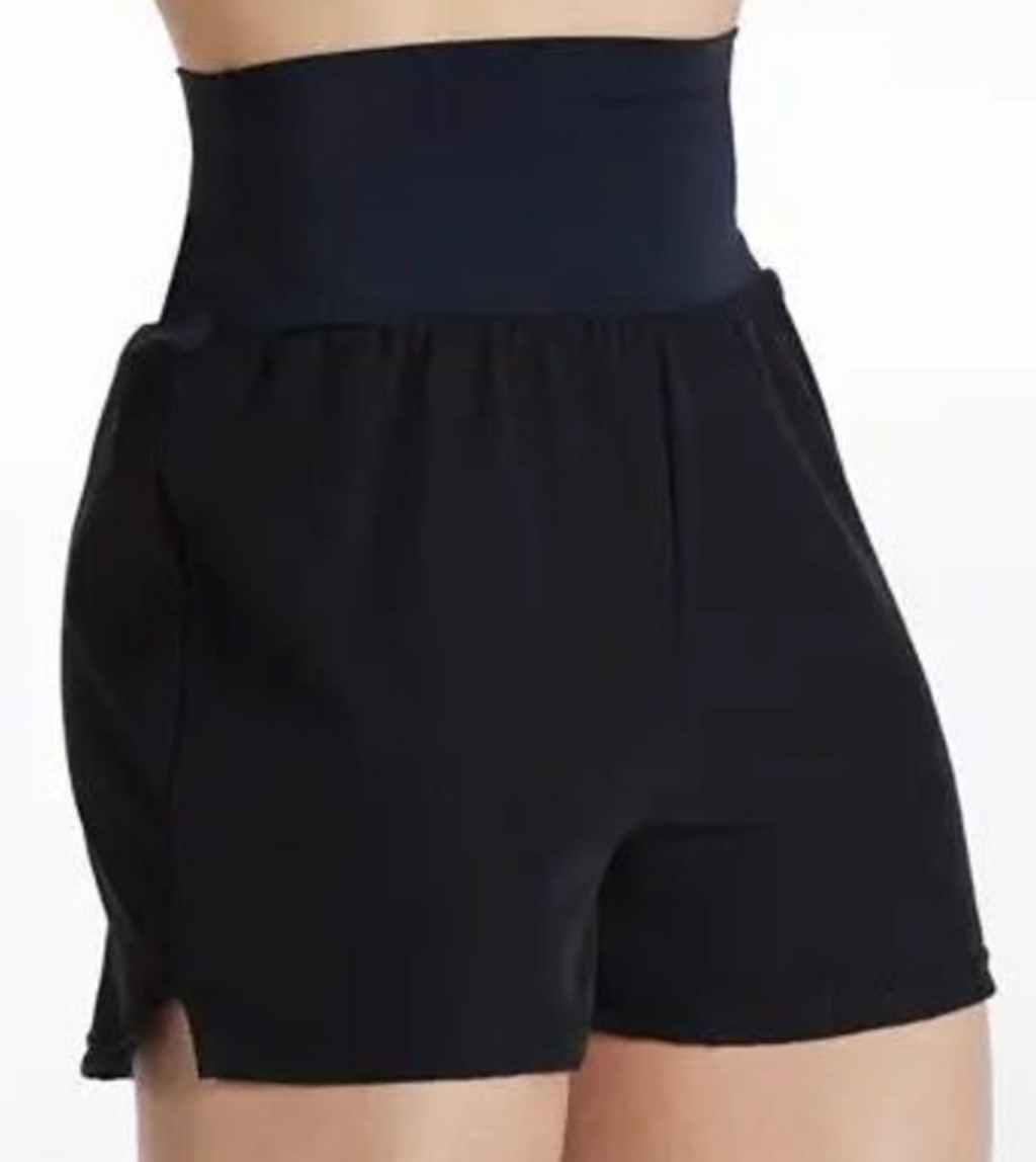 Black high-waisted athletic shorts on a model against a white background featuring a wide dark waistband, gathered details below the waist, and a slight side slit