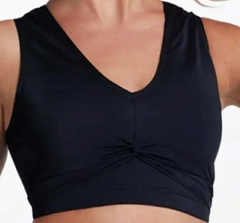 A close-up of a black V-neck sports bra featuring a twisted knot detail at the center front and smooth performance fabric