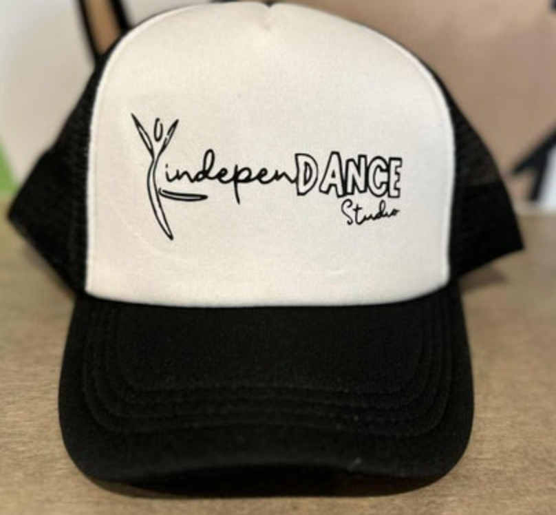 Black and white trucker hat featuring the YindependANCE Studio logo with a stylized dancing figure on the white front panel and a black mesh back and brim