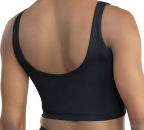 A person's upper back and shoulders with tan skin wearing a plain black scoop-neck crop top made of smooth fabric on a white studio background