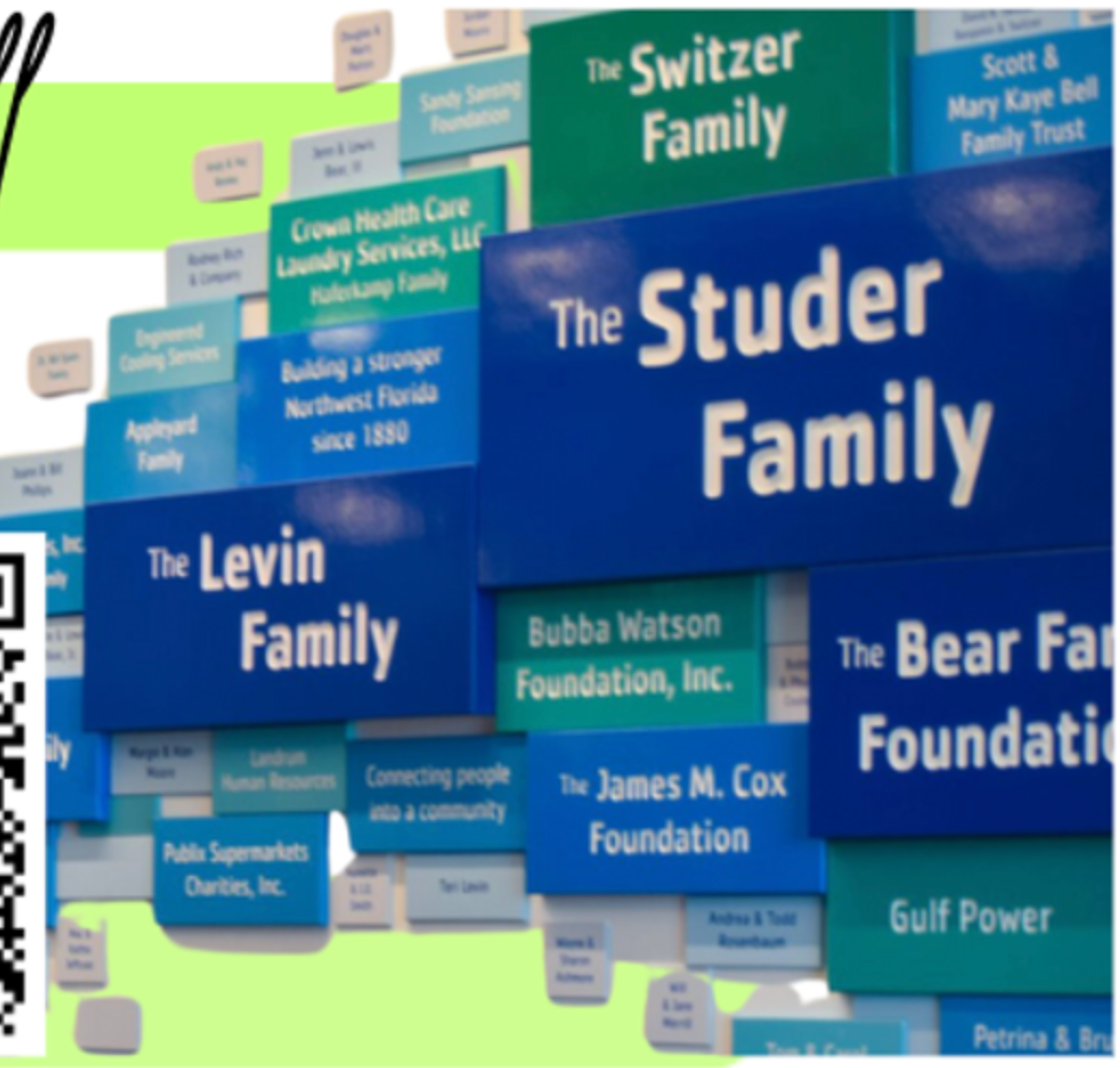 Multimedia donor recognition wall featuring vibrant blue and green tiered plaques with names like The Studer Family, The Levin Family, The Switzer Family, Bubba Watson Foundation, and Publix Supermarkets Charities, acknowledging contributions in Northwest Florida