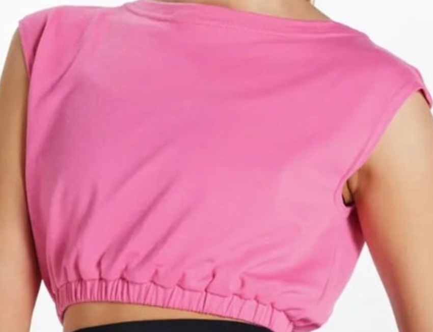 A vibrant fuchsia pink sleeveless cropped top featuring a stylish elasticized hem and soft fabric detail