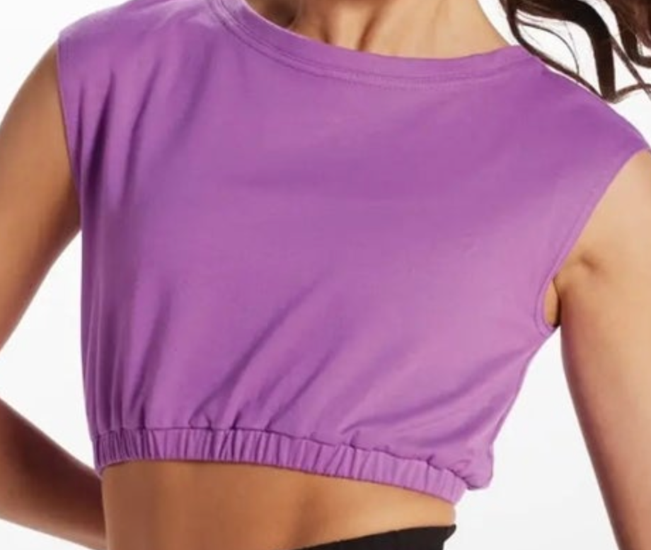 Photograph of a woman's torso wearing a vibrant purple sleeveless crop top with a rounded neckline and an elasticated hem