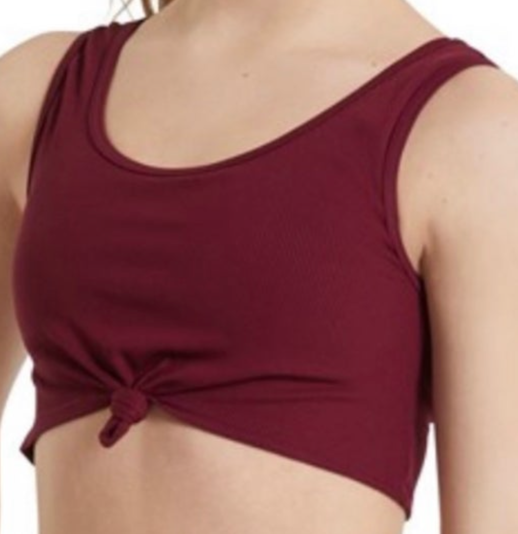 A person wearing a maroon ribbed crop top with a front tie-knot