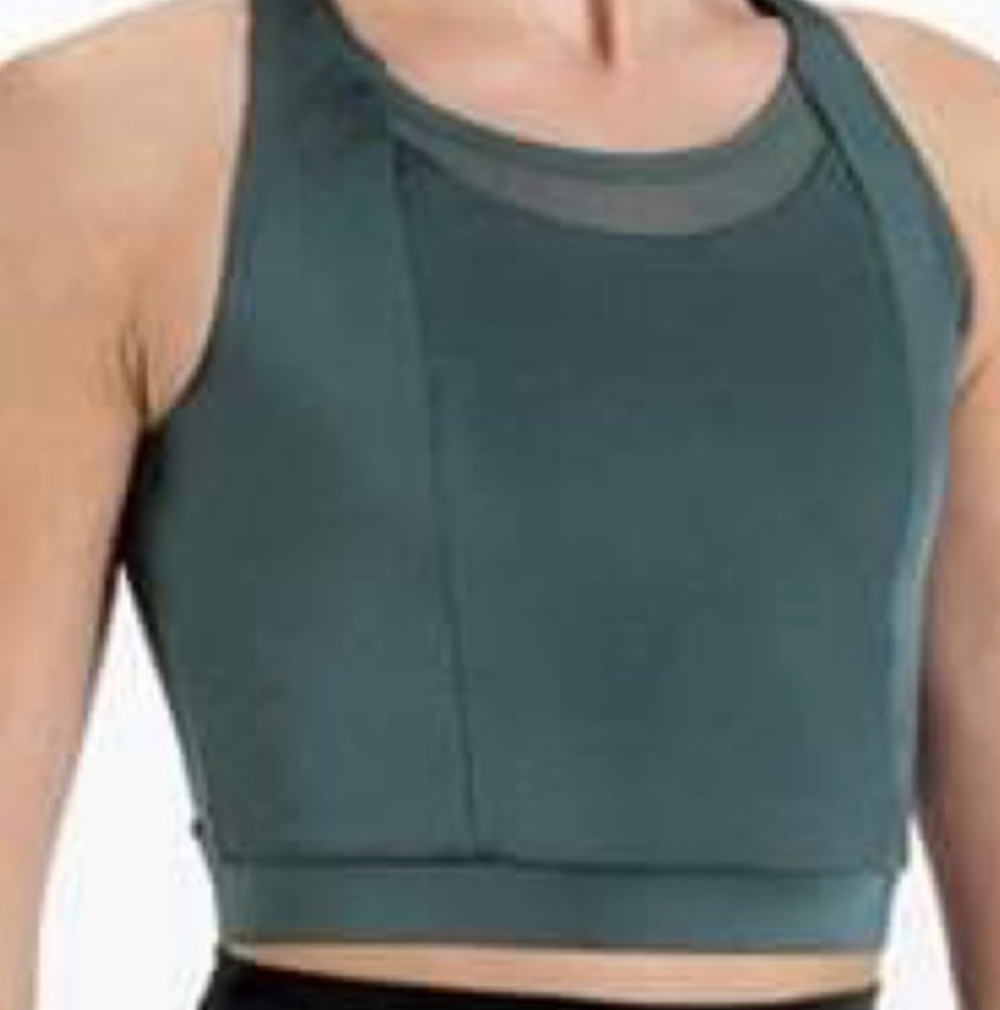 Torso of a person wearing a dark teal athletic crop top with a sheer mesh high neckline and wide racerback straps
