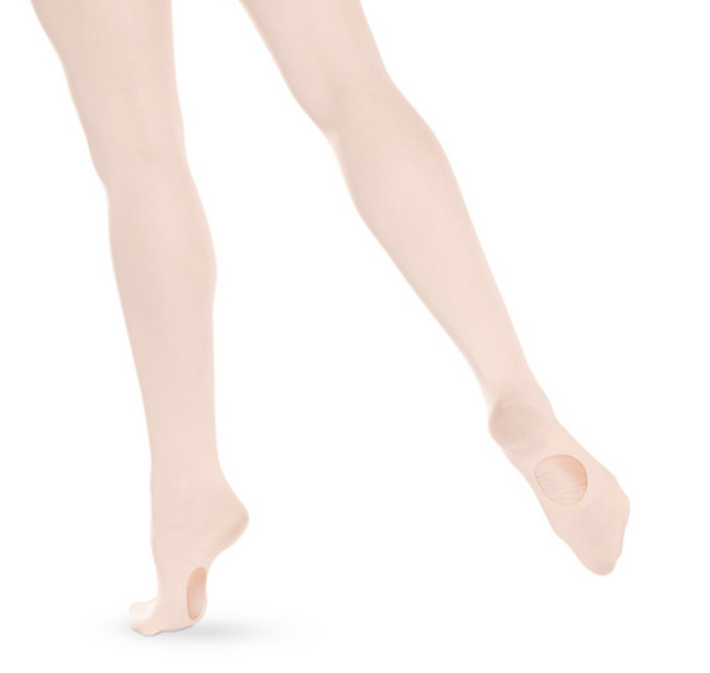 Photograph of dancer's legs wearing light pink convertible ballet tights, highlighting the foot openings and smooth fabric against a plain white studio background