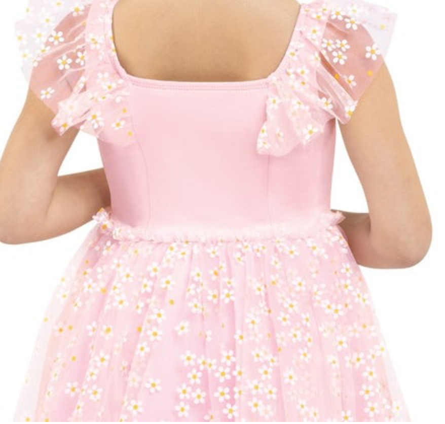 Rear view of a child in a light pink dress with a square neckline, sheer ruffled sleeves, and a skirt adorned with small white daisies that have yellow centers