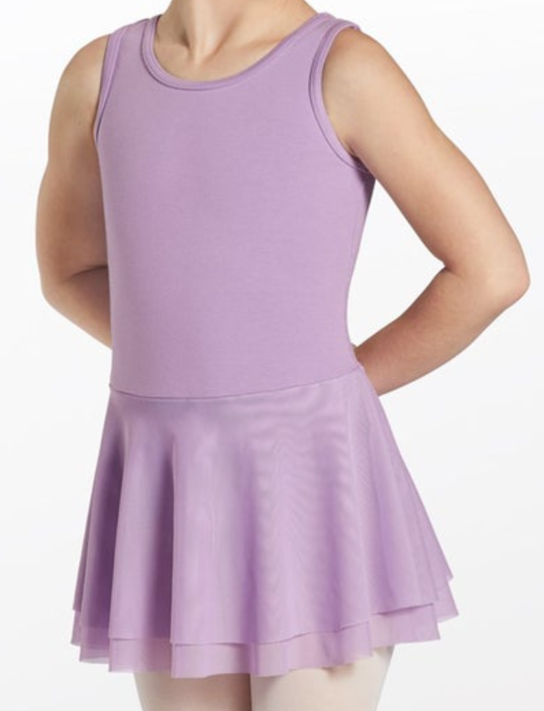 Photograph of a young child modeling a lavender sleeveless dance leotard and matching double-layered chiffon skirt with hands behind their back over pale pink tights