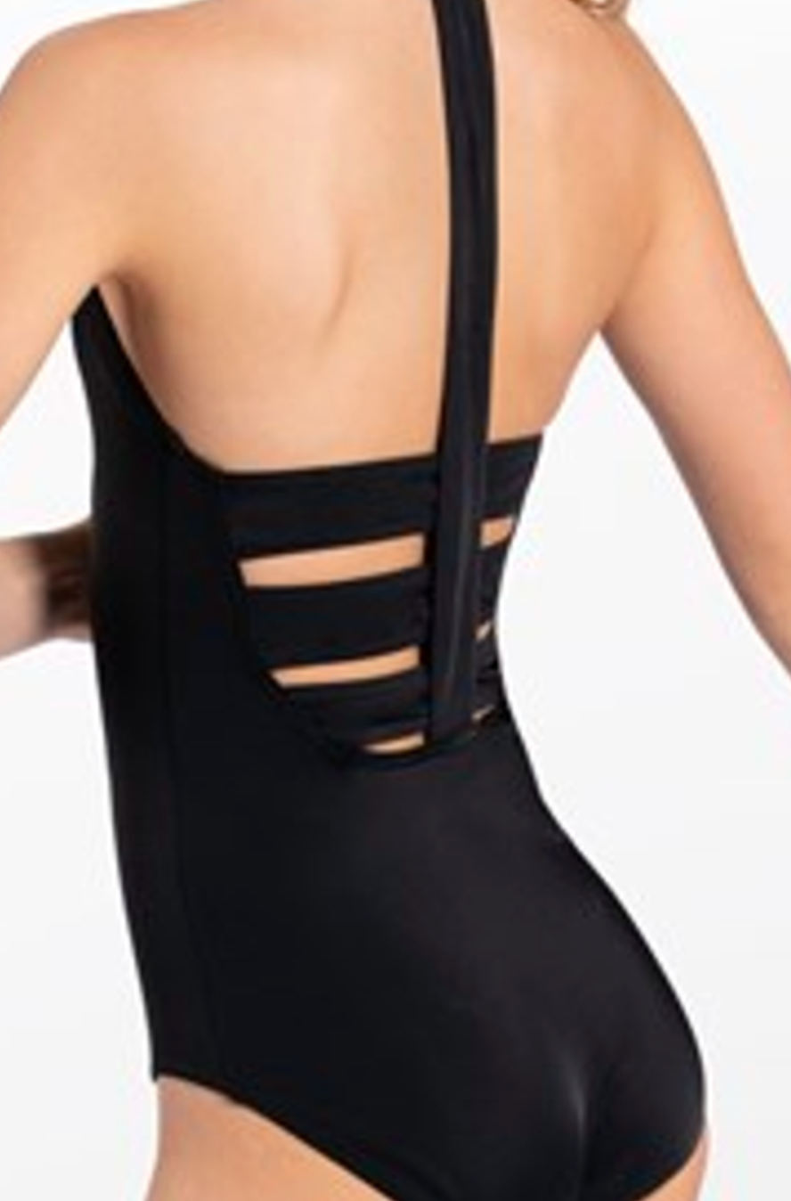 Black one-piece dancewear on a woman's back featuring a wide central halter strap and four horizontal back straps