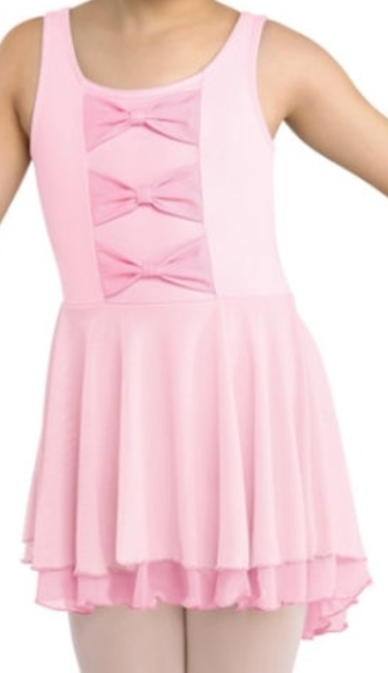 A young dancer wearing a sleeveless pink ballet leotard dress featuring three matching pink bows on the front bodice and a flowing layered skirt over light-colored ballet tights